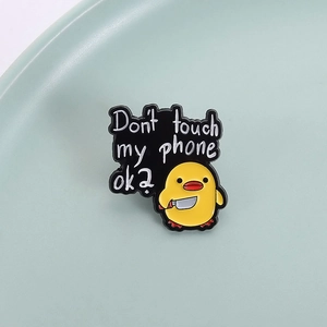 Funny yellow duck enamel pin holding a knife with Don't touch my phone text design