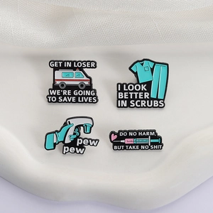 Set of four medical enamel pins featuring ambulance and scrubs on a white tray