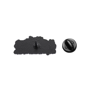 Detail view of the enamel pin back with metal texture and black rubber clutch attachment
