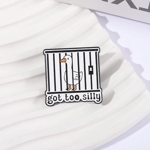 Cute cartoon goose in a cage enamel pin with 'got too silly' text on a wavy display