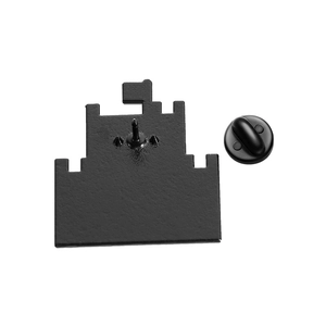 Detailed back view of matte black castle badge with secure rubber clutch and single pin