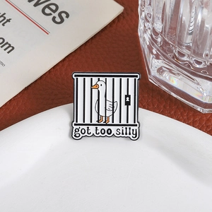 Funny white goose enamel pin inside a black cage featuring Got Too Silly text