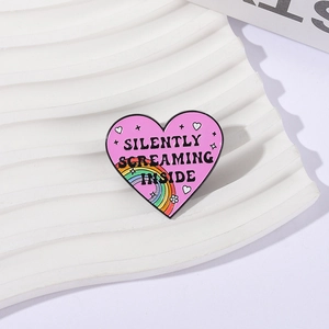 Pink heart enamel pin with Silently Screaming Inside text and rainbow on white background