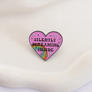 Pink heart enamel brooch with Silently Screaming Inside text and rainbow star detail