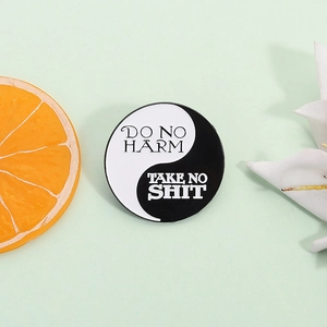 Creative Yin Yang Tai Chi enamel pin with Do No Harm Take No Shit text on green background