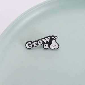 Minimalist black and white enamel pear brooch Grow a pear pins on ceramic plate