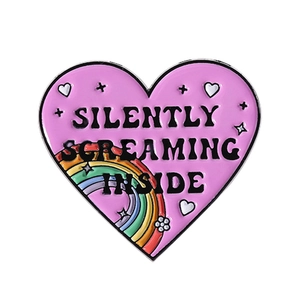 Pink heart enamel pin with Silently Screaming Inside text and rainbow element detail
