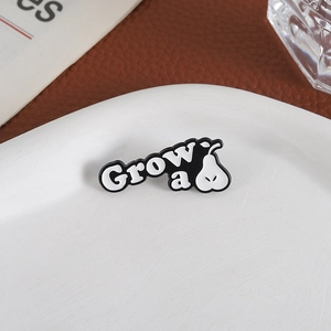 Creative enamel pear brooch featuring Grow a pair pun on a white ceramic plate