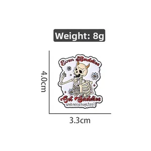 Detailed view of skull enamel pin with daisy floral pattern and punk style text