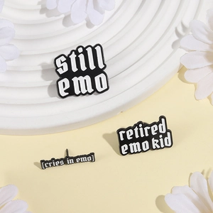 Three-piece black enamel pin set with white emo series text on decorative tray
