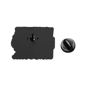 Detailed back view of enamel pin with sharp needle point and black rubber clutch backing