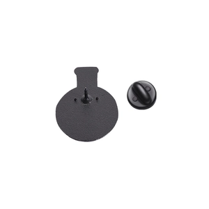 Detail of the back of a black chemical bottle brooch with a secure rubber clutch