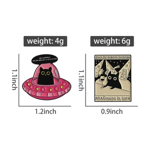 Detailed view of black cat enamel pins showing UFO design and size dimensions