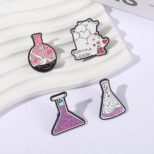 Laboratory chemistry enamel pin set featuring flasks and heart design elements