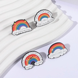 Rainbow cloud enamel pins with funny English slogans on a white textured stand