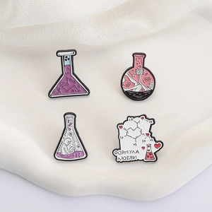 Set of four science lab enamel pins featuring chemistry flasks and test tubes in purple