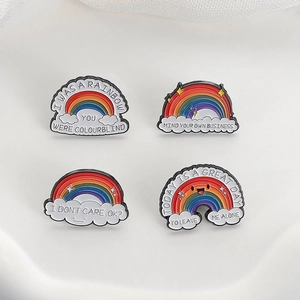 Detail of four rainbow enamel pins with sarcastic slogans on white textured surface