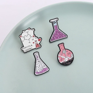 Set of four science themed enamel pins featuring chemistry flasks and love formula