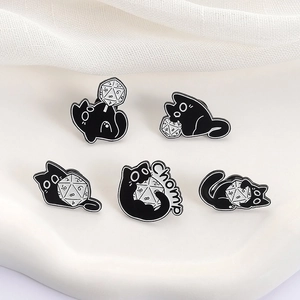 Detail of five creative black cat enamel pins featuring 20-sided dice and metal finish