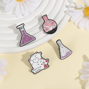 Set of four chemistry science enamel pins with lab flasks and love formula designs