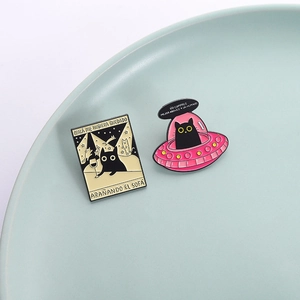 UFO spaceship and black cat enamel pins set featuring a funny cat drinking on a ceramic plate