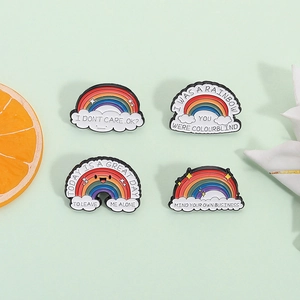 Set of four colorful rainbow enamel pins with humorous quotes on a fresh green background