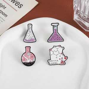 Set of 4 chemistry enamel pins featuring lab flasks and heart formulas on a ceramic plate