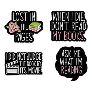 Set of four reading theme enamel pins featuring floral designs and bookish quotes