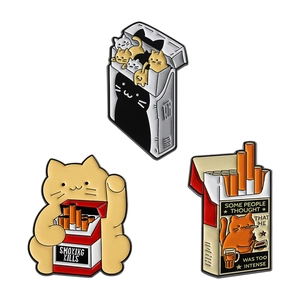 Three creative cat enamel pins with cigarette box design and humorous smoking kills slogan