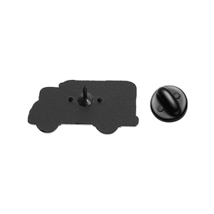 Detail showing back of black enamel pin with metal needle and rubber clutch backing