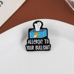 Blue emoji tissue box enamel pin with Allergic to Your Bullshit text on leather background