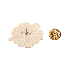 Detail of the golden alloy brooch back with matte texture and butterfly clasp pin