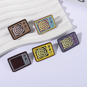 Five vintage TV-shaped enamel pins in colorful retro styles on white display stand