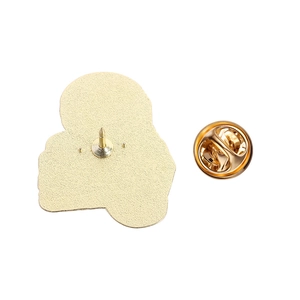 Detailed view of the gold-tone metal brooch back with sandblasted texture and butterfly clasp