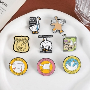 Funny cartoon goose enamel pin set with silly muscle goose designs in white ceramic tray