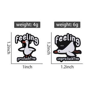 Close-up detail of cartoon duck enamel pins showing weight and dimensions in inches