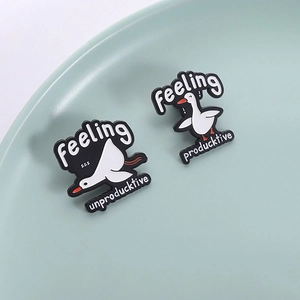 Minimalist white duck enamel pin set featuring funny creative puns on a light green ceramic dish