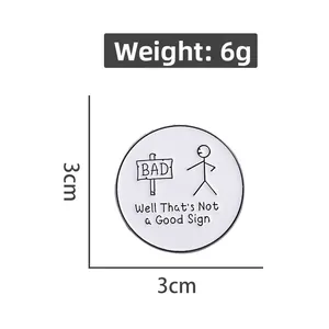 Detail view of round enamel pin showing 3cm diameter and humorous stickman text