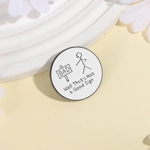 Round enamel pin with stickman design and 'Not a Good Sign' text on yellow background