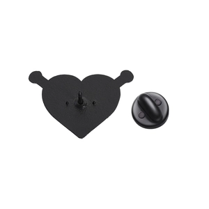 Detail view of the black metal heart brooch back with a secure rubber pin clutch