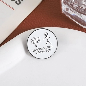 Minimalist stickman metal brooch with humorous 'Not a Good Sign' text and enamel finish