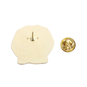 Macro view of gold metal pin back with sharp needle and butterfly clutch fastener