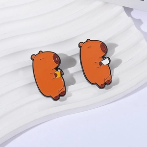 Set of two cute capybara enamel pins featuring reading and drinking coffee designs