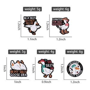 Detailed view of white goose enamel pins with size measurements and weights in grams