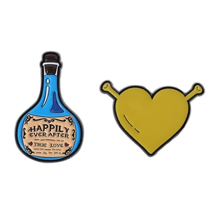 Mini enamel pin set with blue potion bottle and yellow ogre heart shaped badges