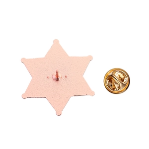 Detailed back view of a hexagonal star brooch pin with rose gold butterfly clutch closure