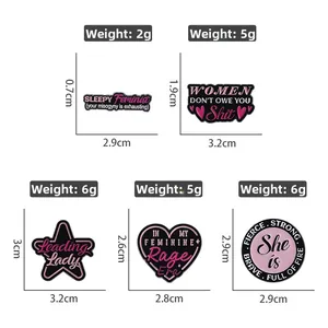 Detailed view of feminist enamel pins with precise dimensions and weight measurements