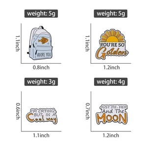 Set of four unique enamel pins with musical and creative quotes and cute sun fish designs