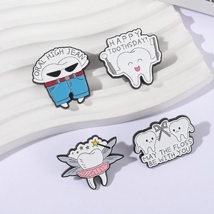 Set of four creative enamel teeth brooches with dental care themes on white waves