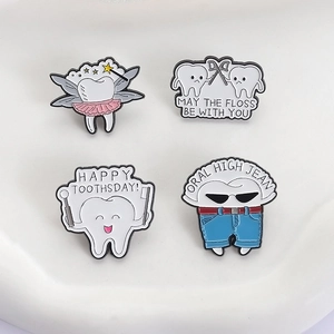 Set of 4 creative enamel pins featuring tooth dental care themes on white surface